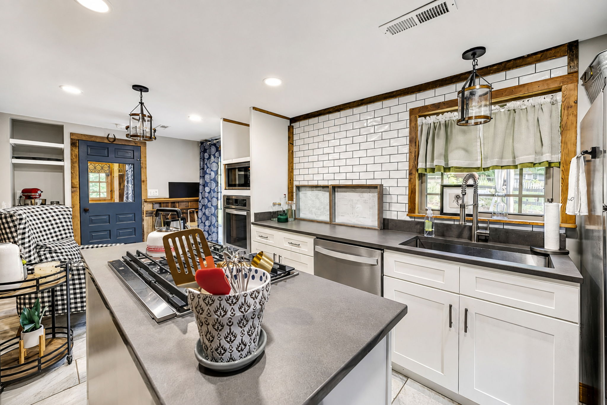 Full guest cabin kitchen with island, subway tile and generous cabinetry
