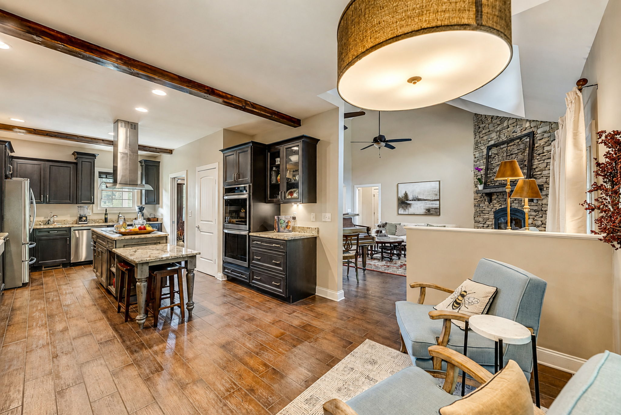 Open view from the kitchen into the fireside living spaces of the main residence