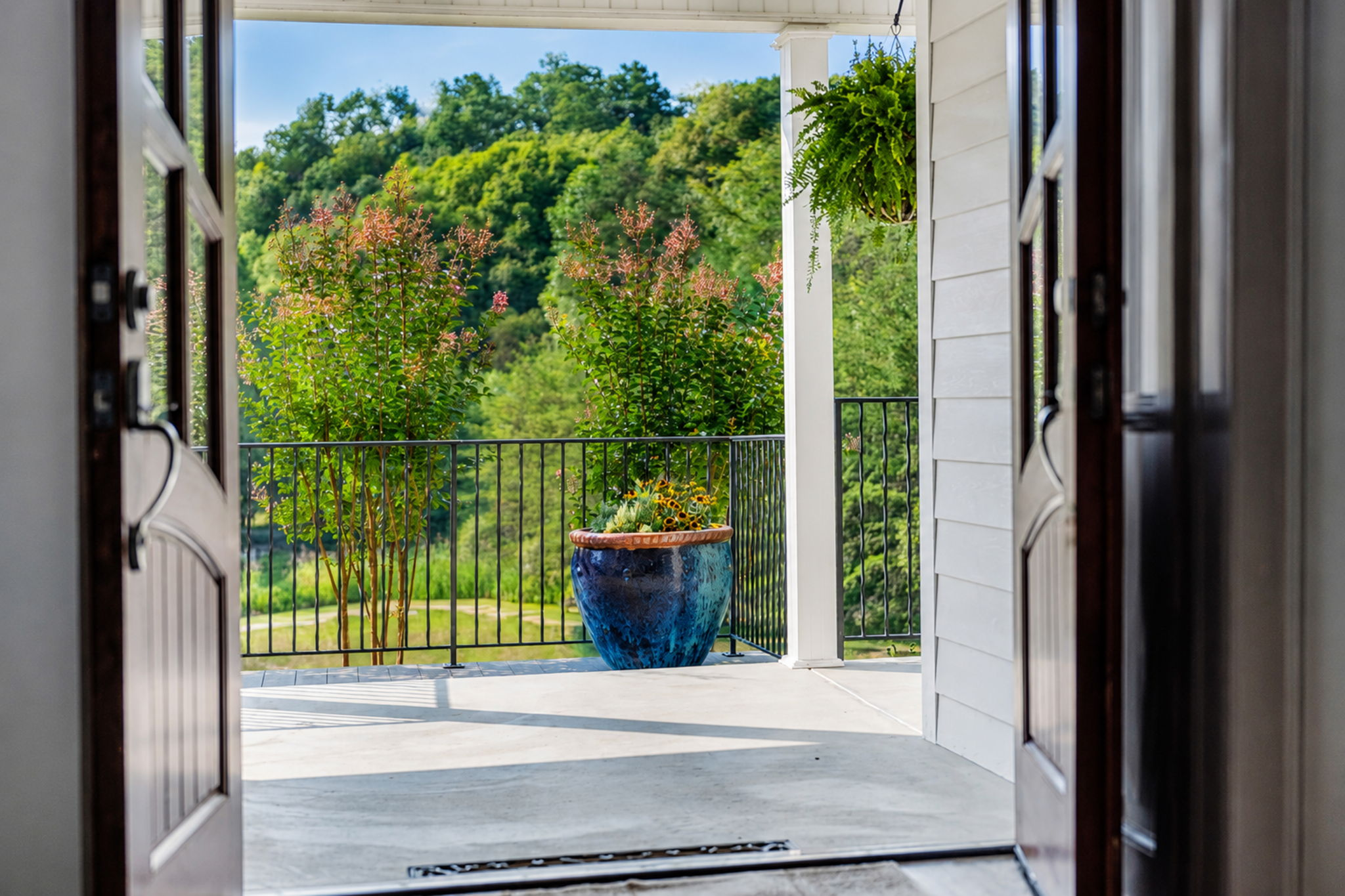 Open doors framing the private grounds from inside the residence